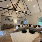 Living room with comfy sofas and wooden beams